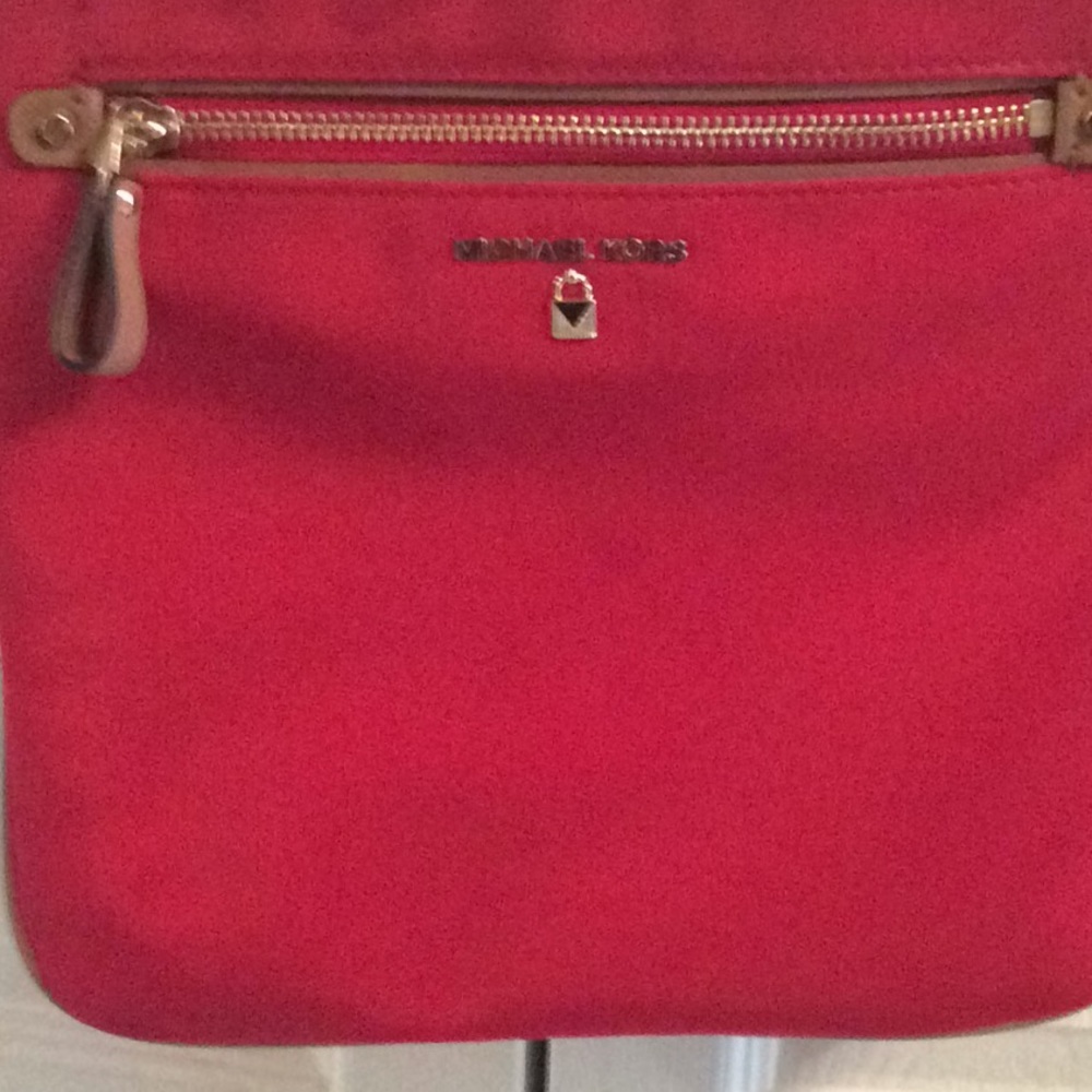 Michael Kors red vinyl crossbody bag.